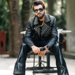 A picture of Kashish Kumar sitting with a mic in hand